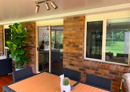 rear house Shiny windows on brick home